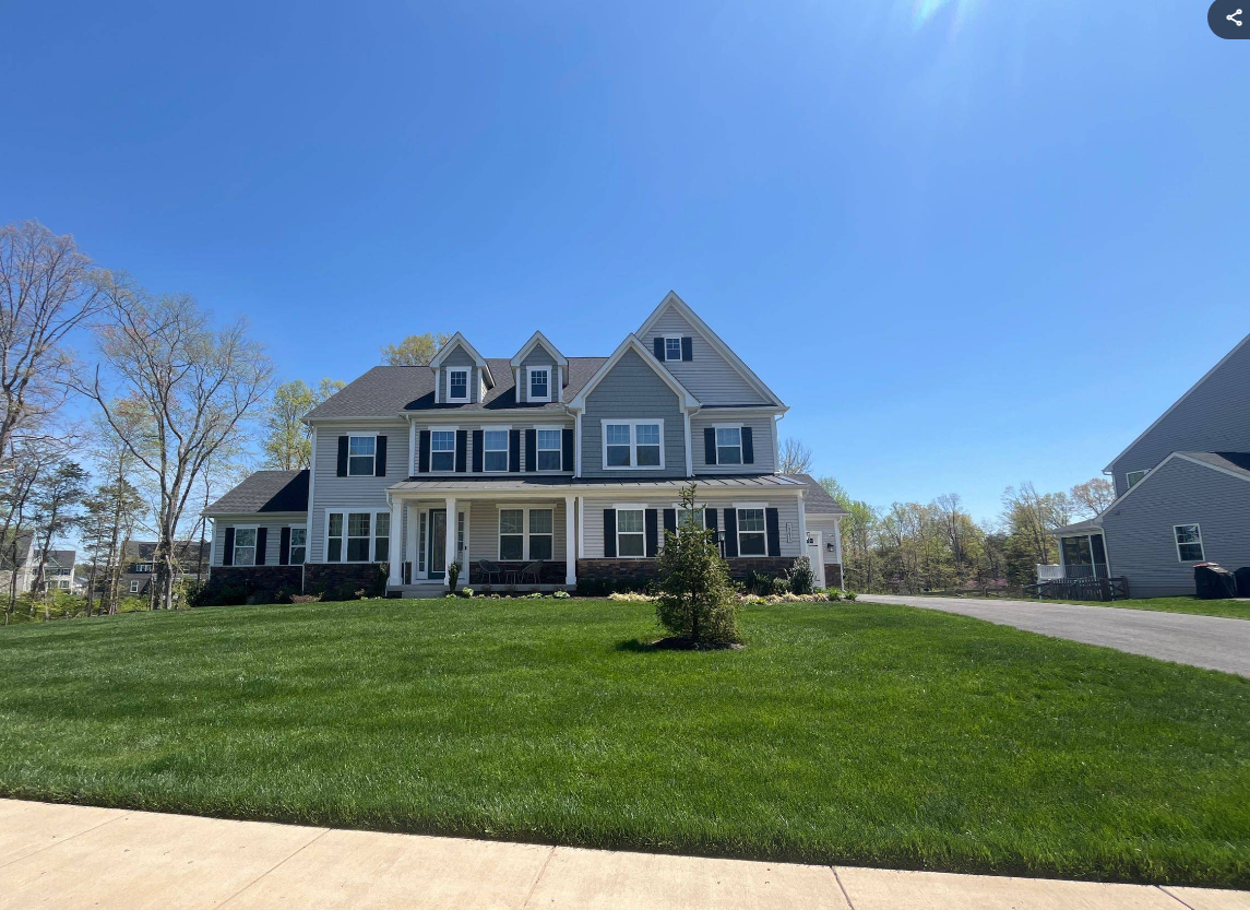 A large house with a large lawn in front of it.