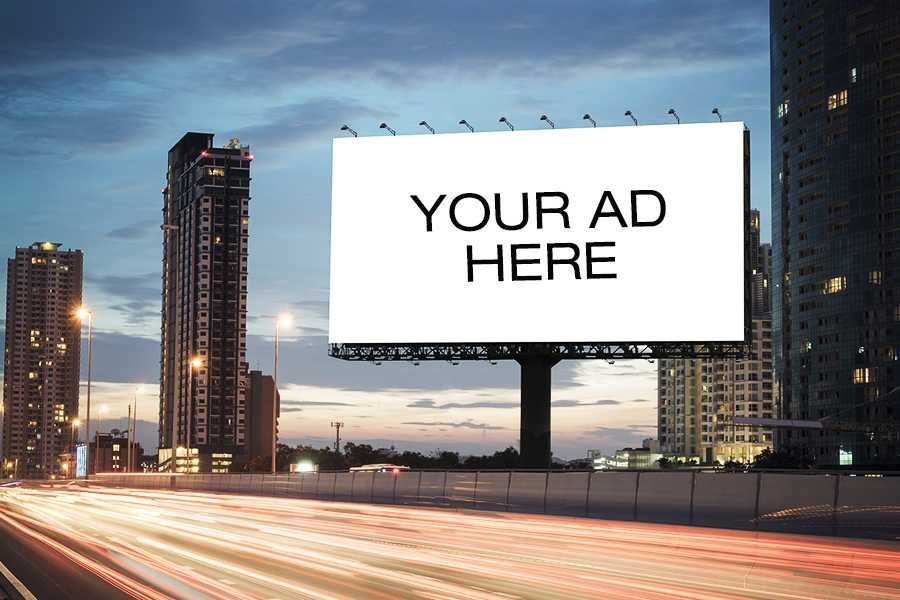 A billboard on the side of a highway that says your ad here