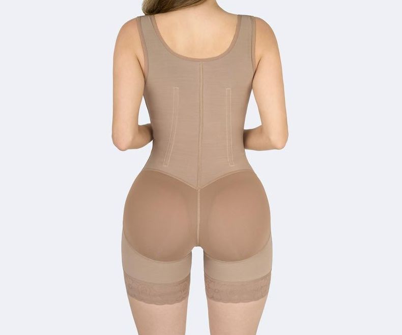Rear view of a person wearing a beige body shaper with shorts.