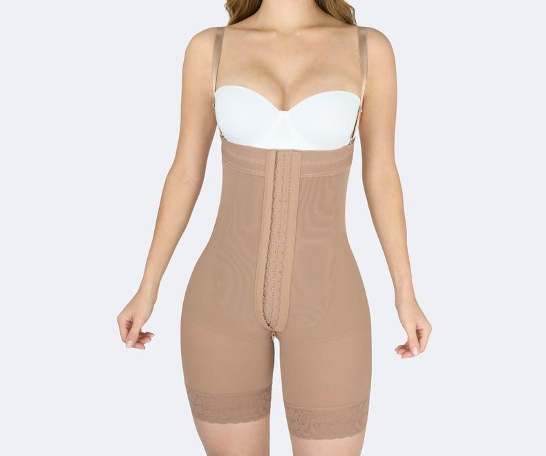 Woman wearing a beige body shaper with adjustable straps, hook-and-eye closure, and shorts-style legs.