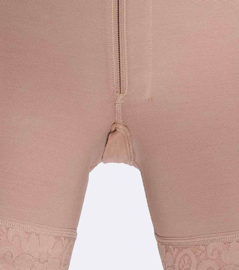Close-up of beige compression garment, with zipper closure and lace trim on legs.