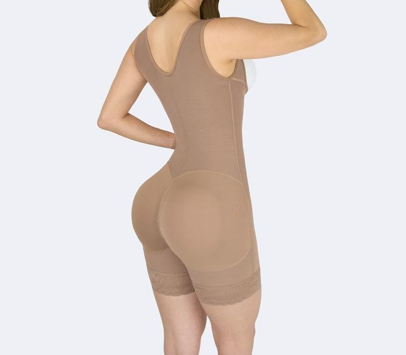 Tan compression bodysuit on a person, rear view. Sleeveless with shorts.