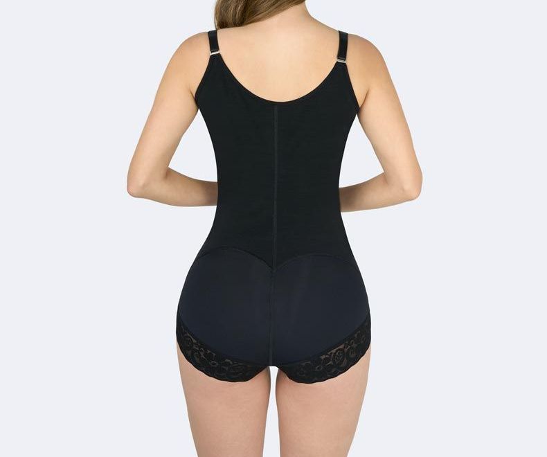 Black bodysuit shapewear on a person from the back. Features straps, zipper front, and lace trim on the bottom.