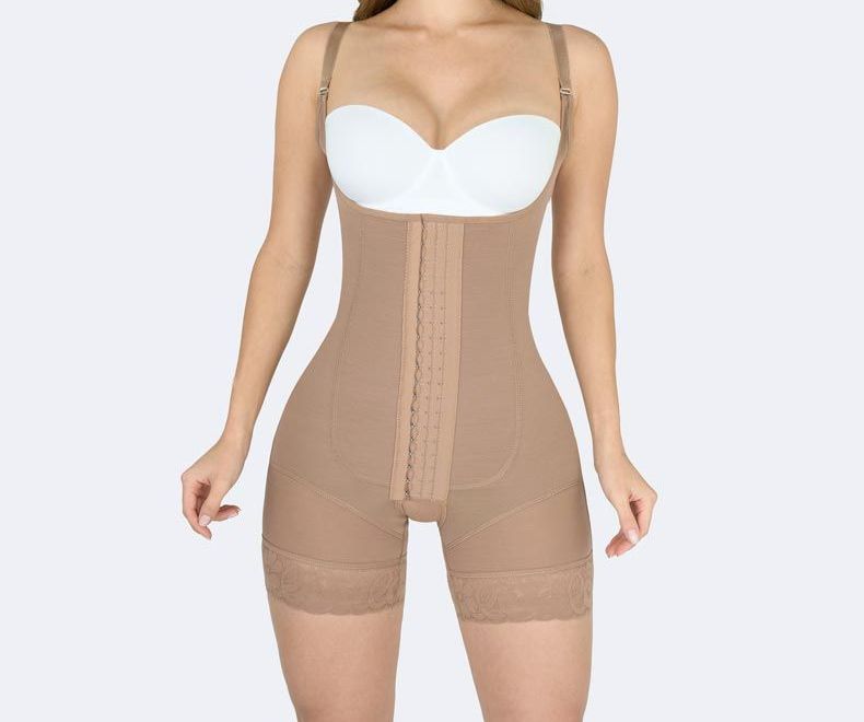 Woman wearing a beige body shaper with adjustable straps, hook-and-eye closure, and short legs.