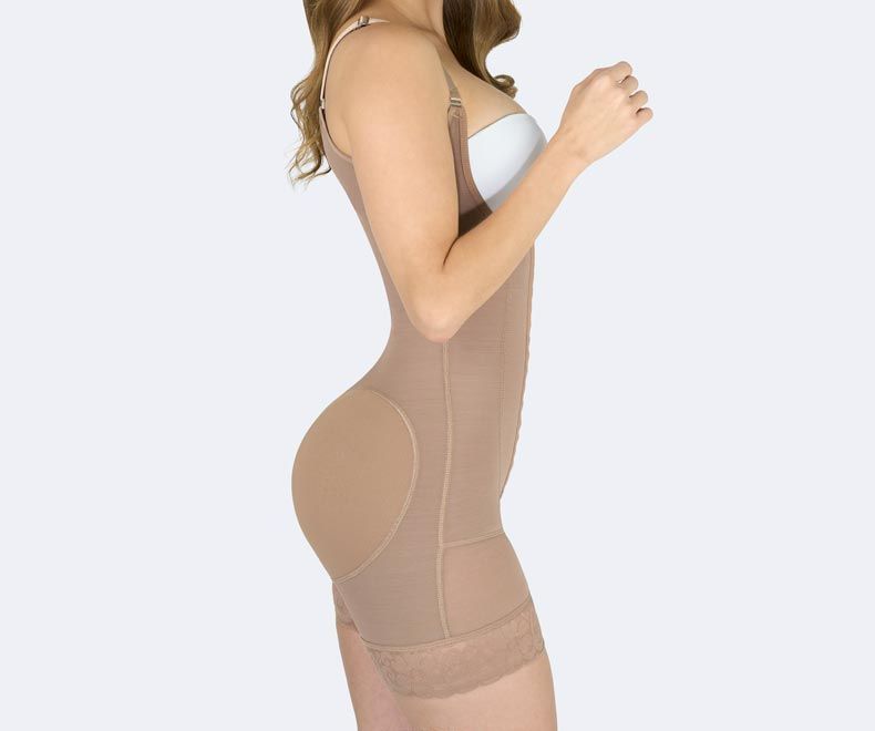 Side view of a person wearing a beige body shaper with adjustable straps.