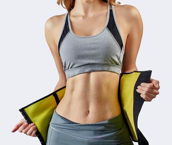 Woman in workout clothes with sweat belt, torso visible, gray and yellow.