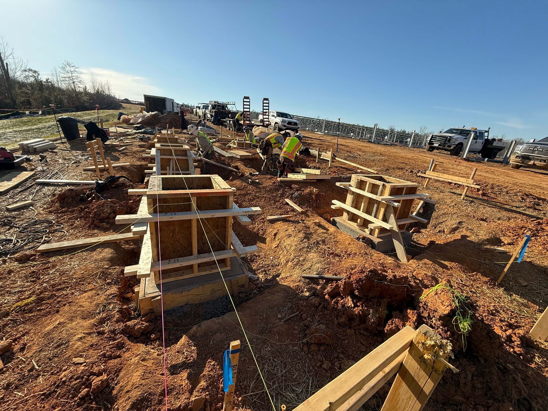 A person is standing next to a wooden box on a construction site.