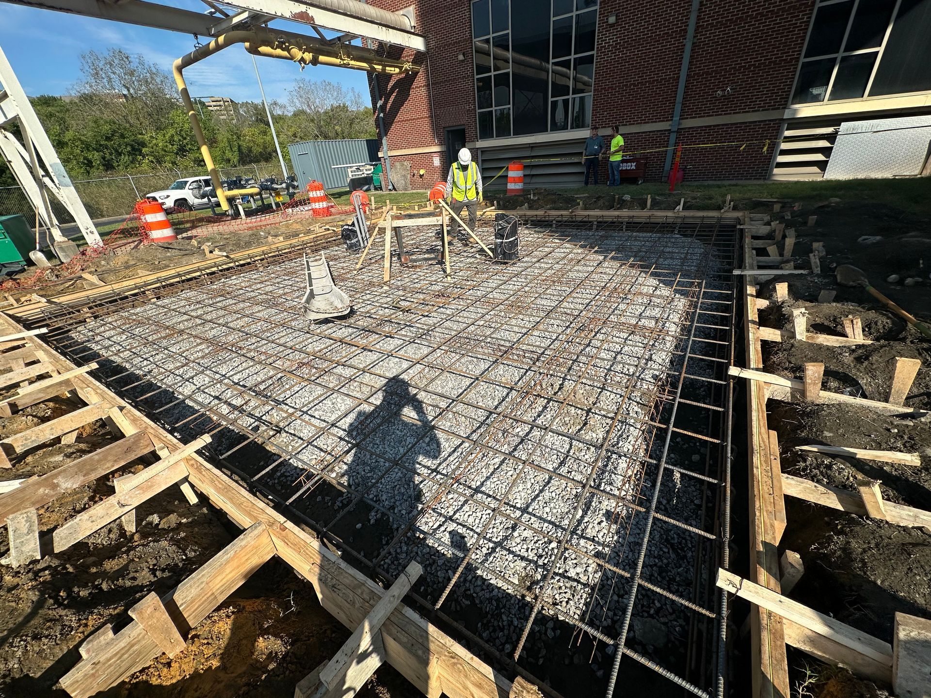 Construction site with concrete forms for foundation footings.