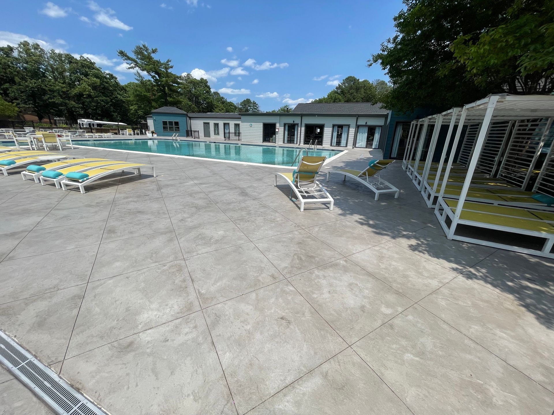 A large swimming pool with a lot of chairs around it