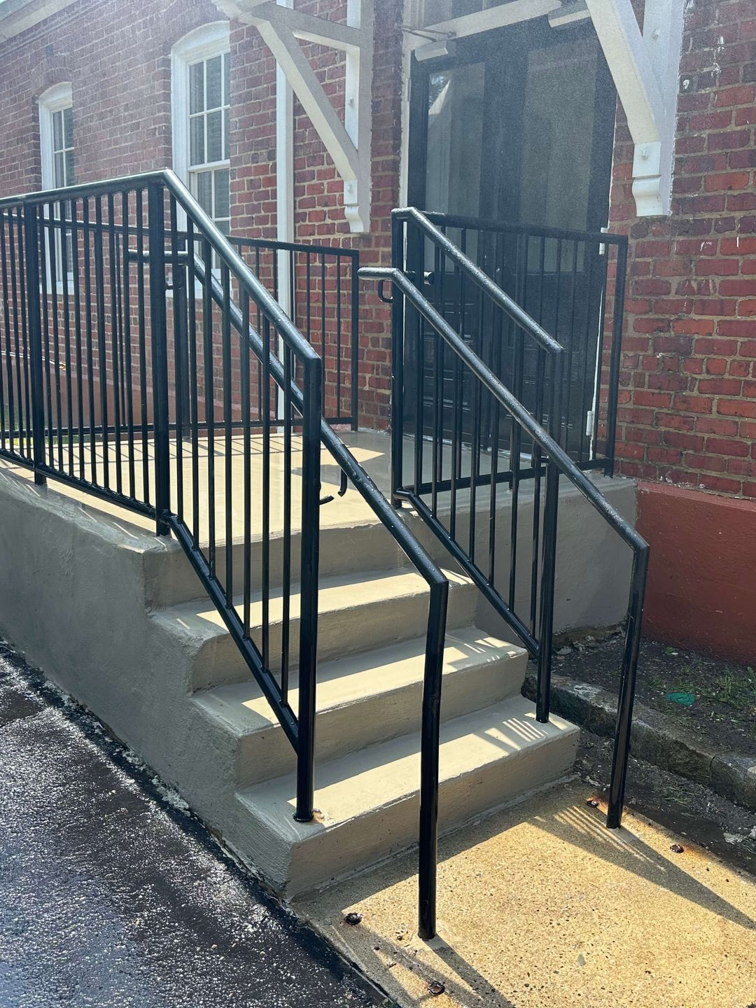 An empty barn with a concrete floor and a wooden roof. Project done by Raise the Bar Construction