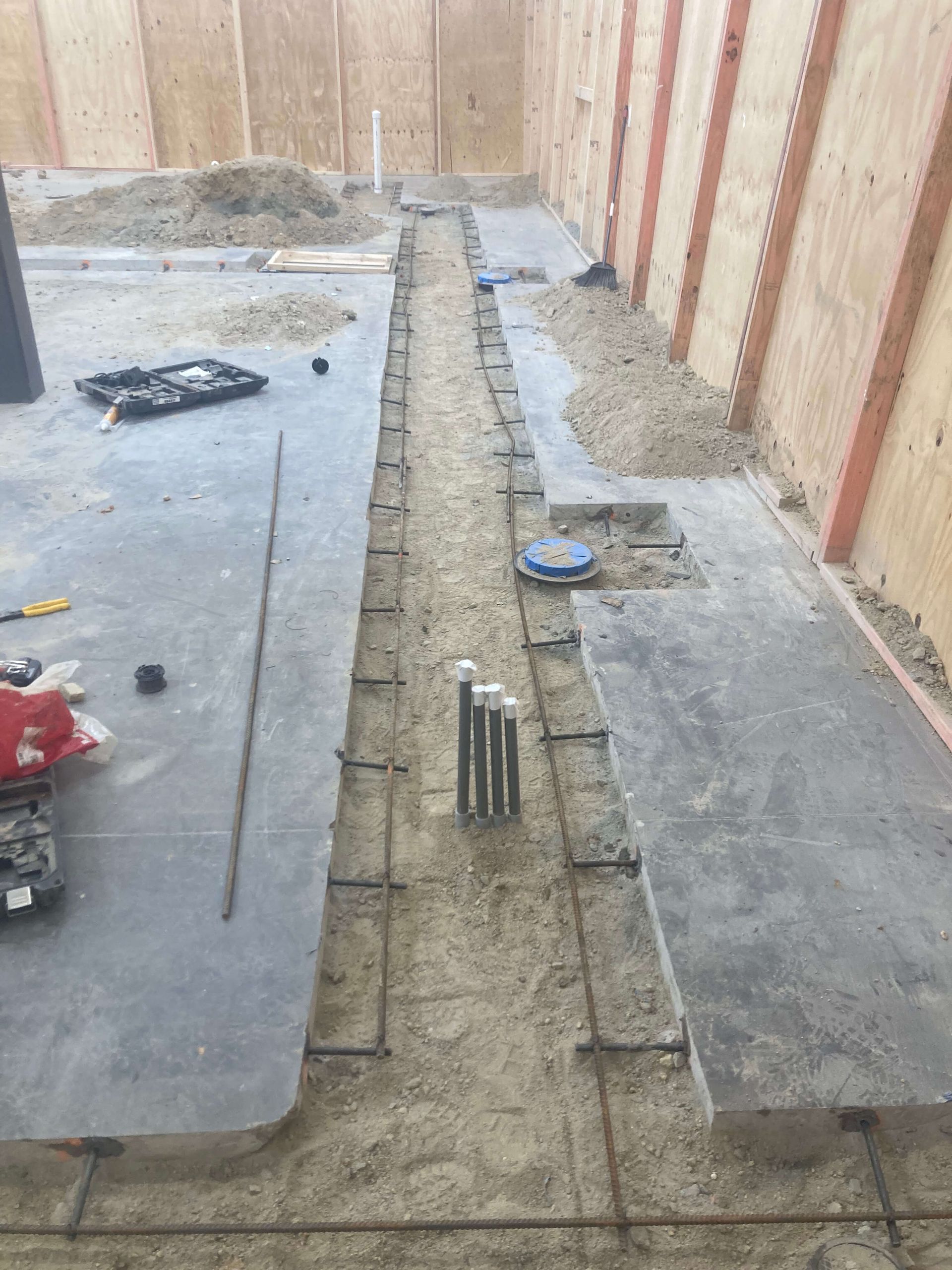 A concrete floor is being built in a basement.