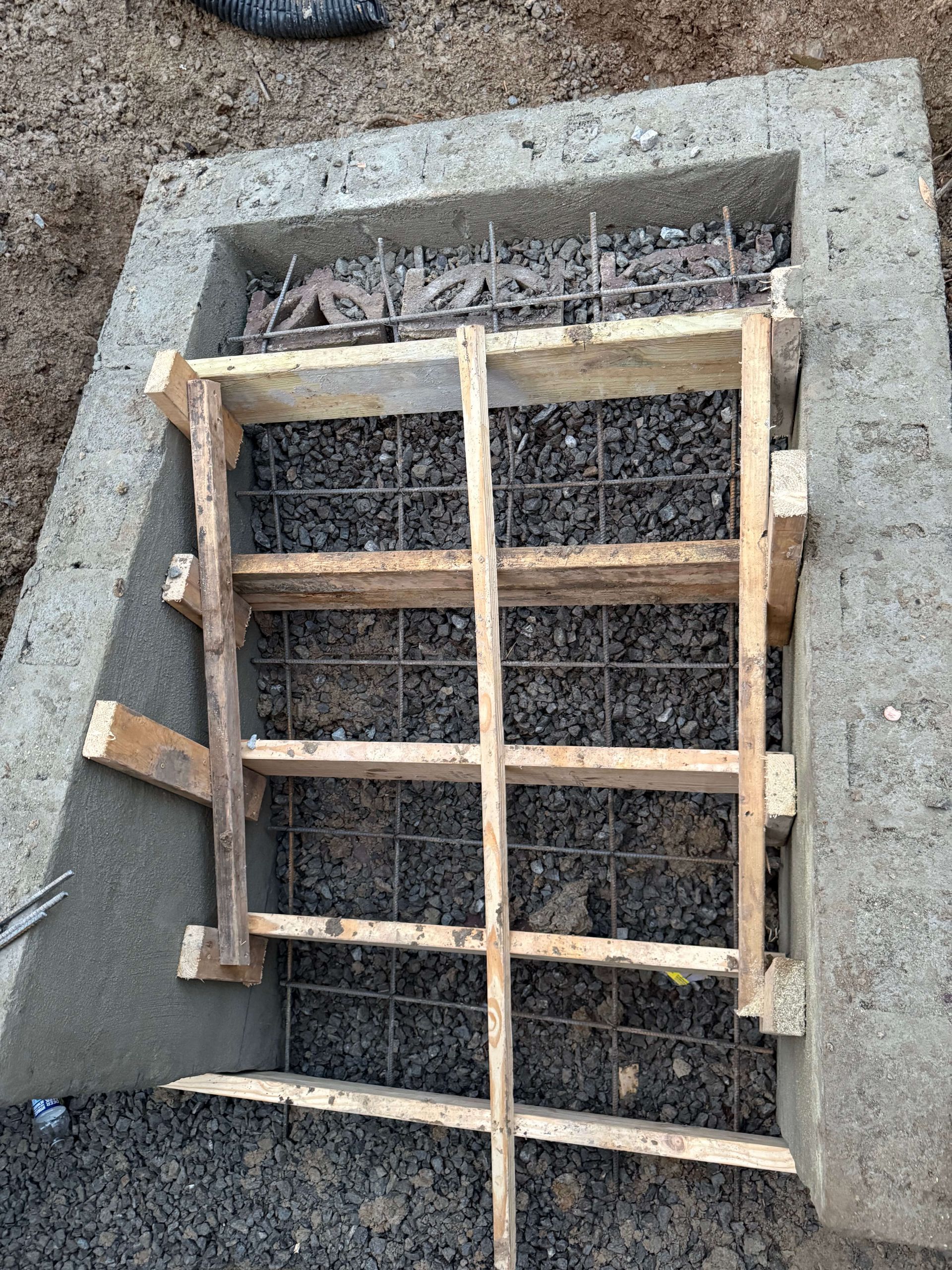 A wooden frame is sitting on top of a concrete block.