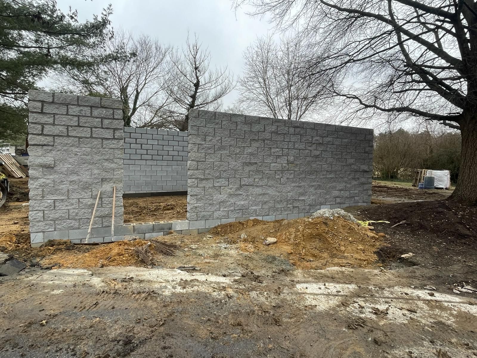 A brick house with a concrete driveway in front of it.