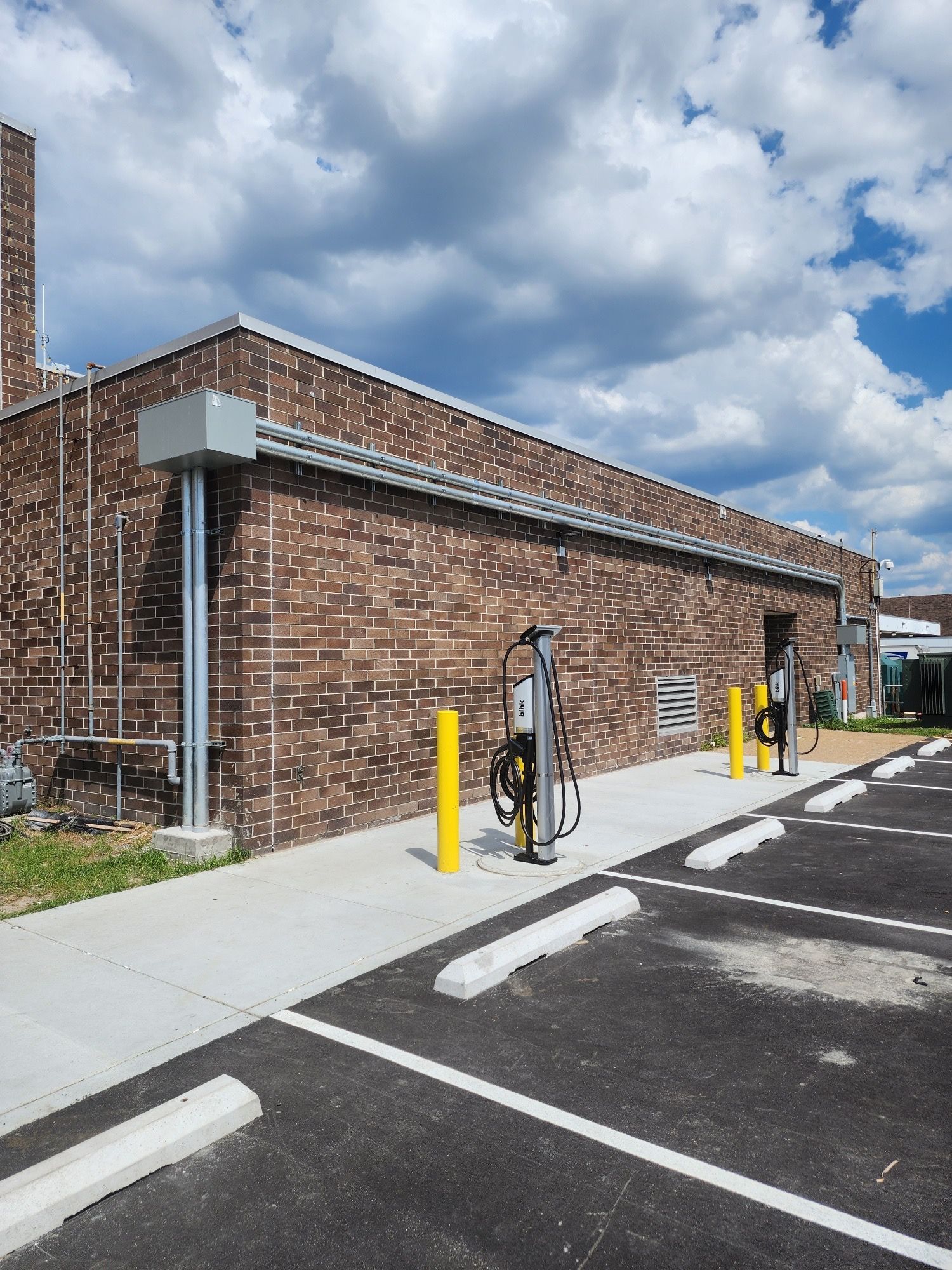 A brick building with a parking lot in front of it