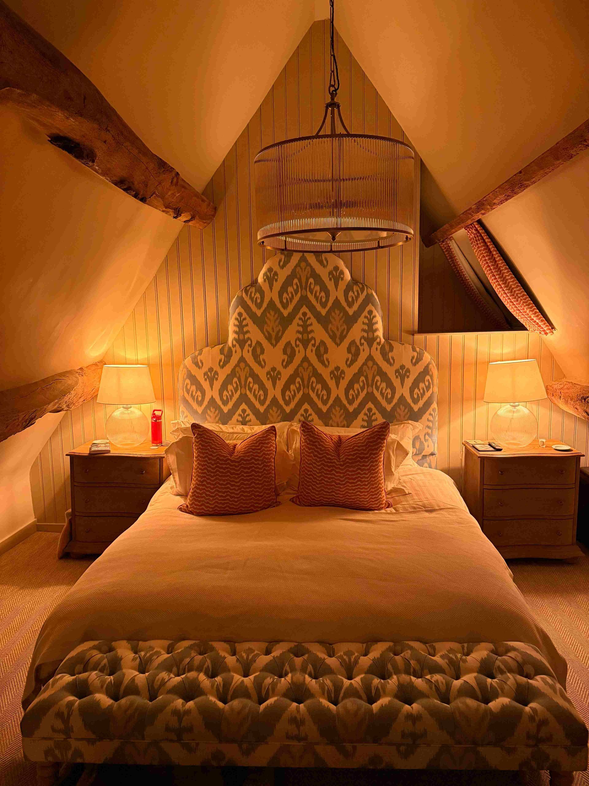 Converted loft room with a pitched ceiling and wooden beams.