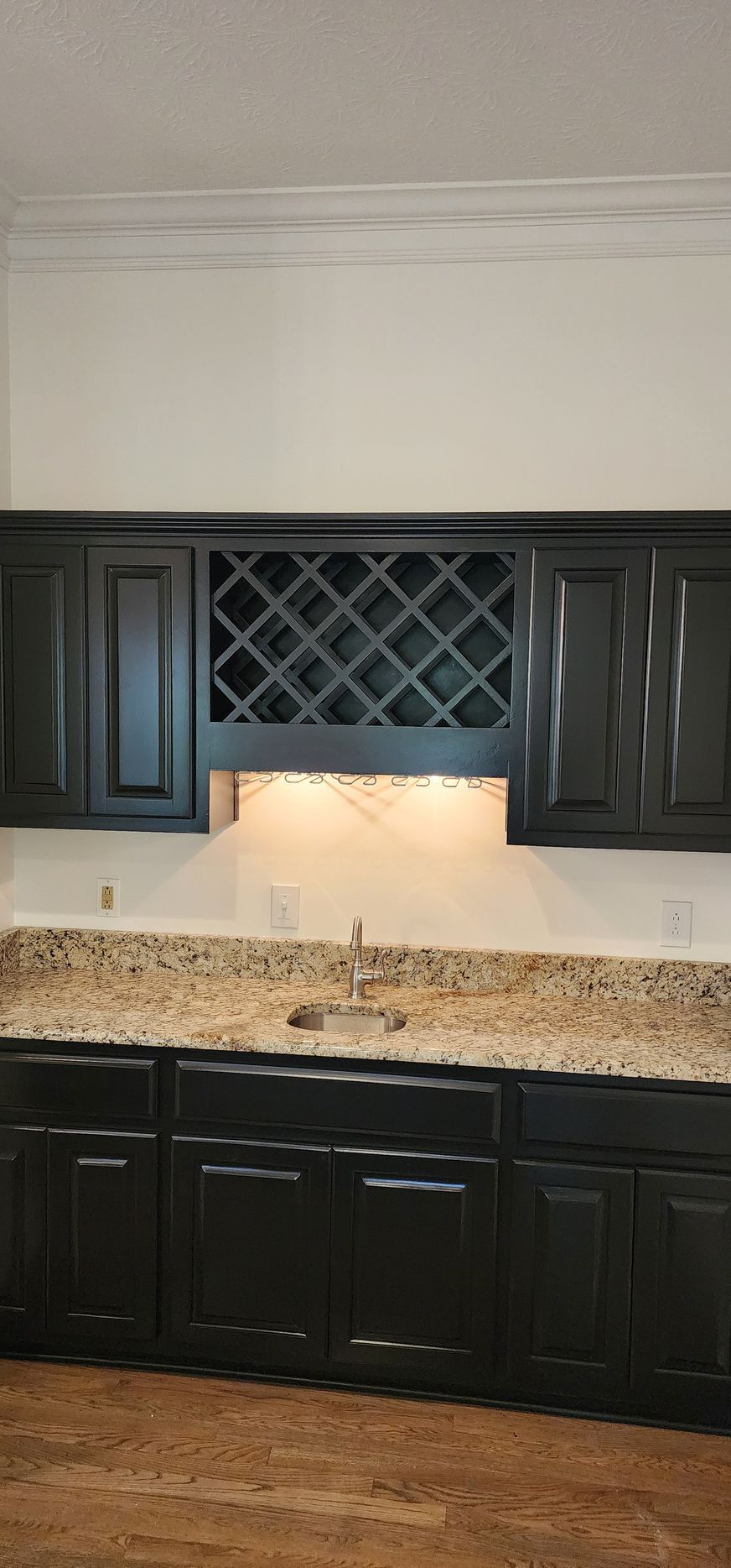A kitchen with wooden cabinets and a wine rack -Harrodsburg, KY Southern Elite Coatings LLC 