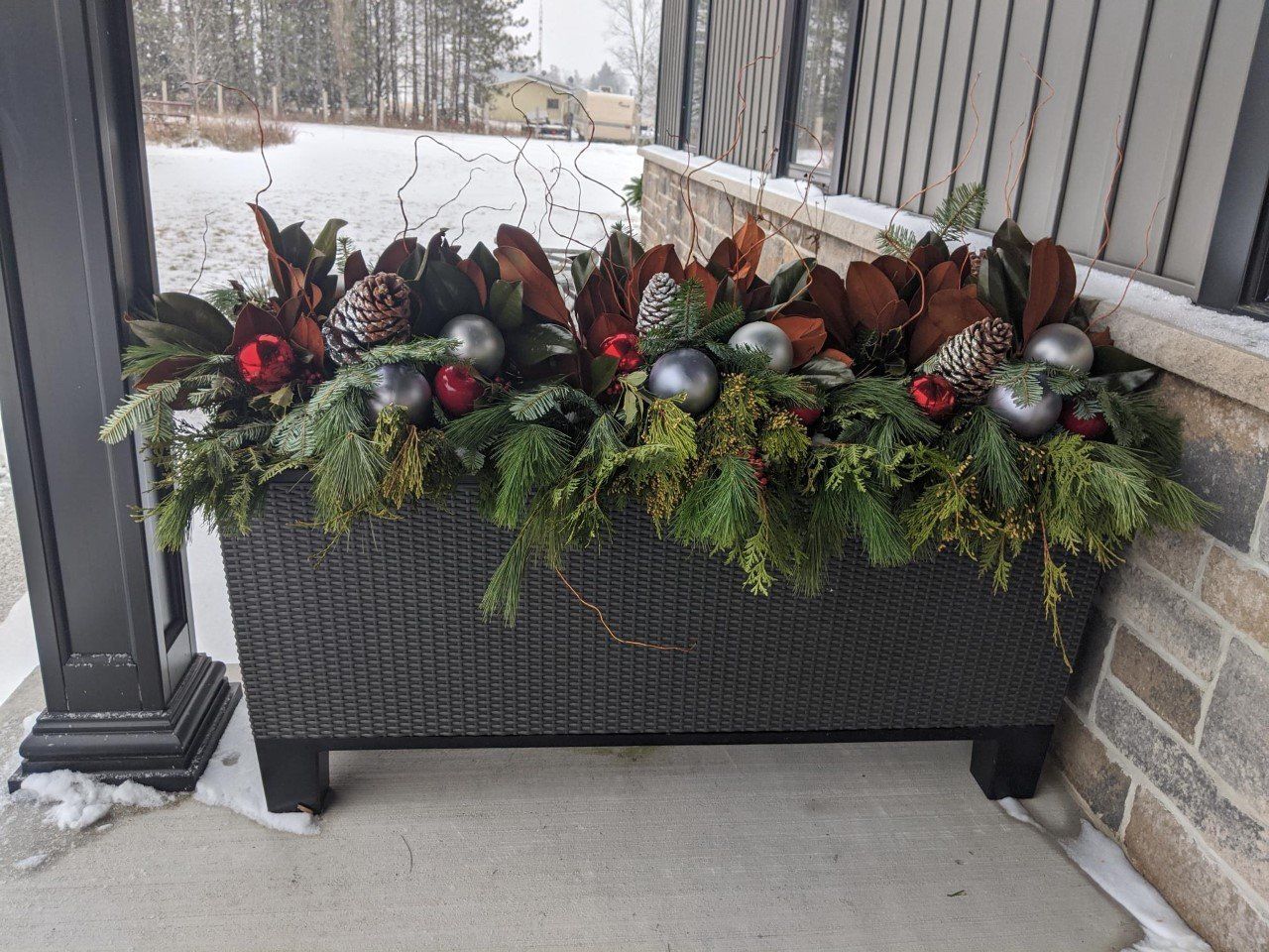 Large Christmas container with greenery.