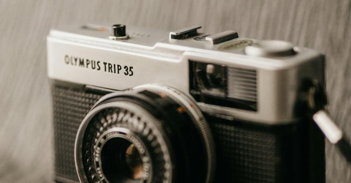 An old olympus trip 35 camera is sitting on a table.