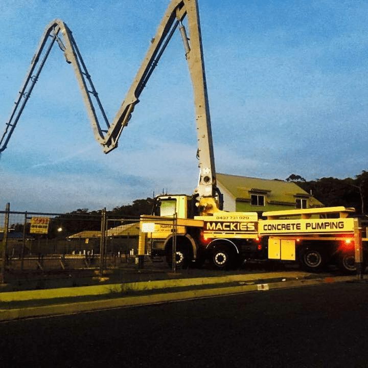 A Mackie's Concrete Pumping Truck is Parked on the Side of the Road — Mackie's Concrete Pumping In Old Bar, NSW