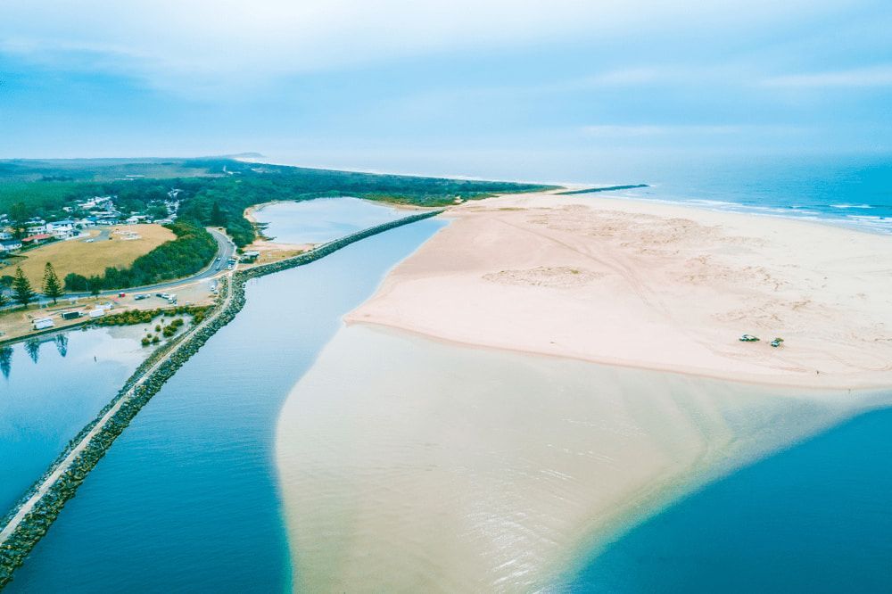 An Aerial View of a River and a Sandy Beach — Mackie's Concrete Pumping In Harrington, NSW