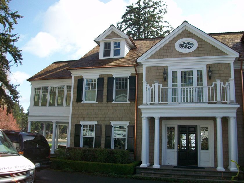 A large house with a car parked in front of it