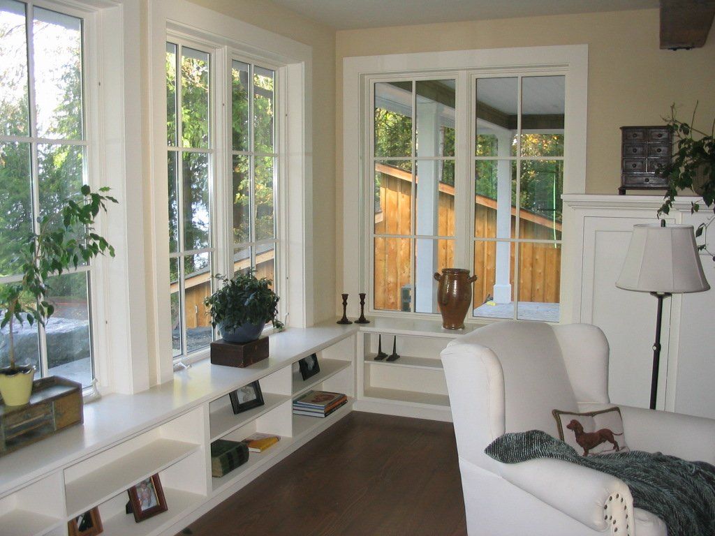 A living room with a white chair and a lamp