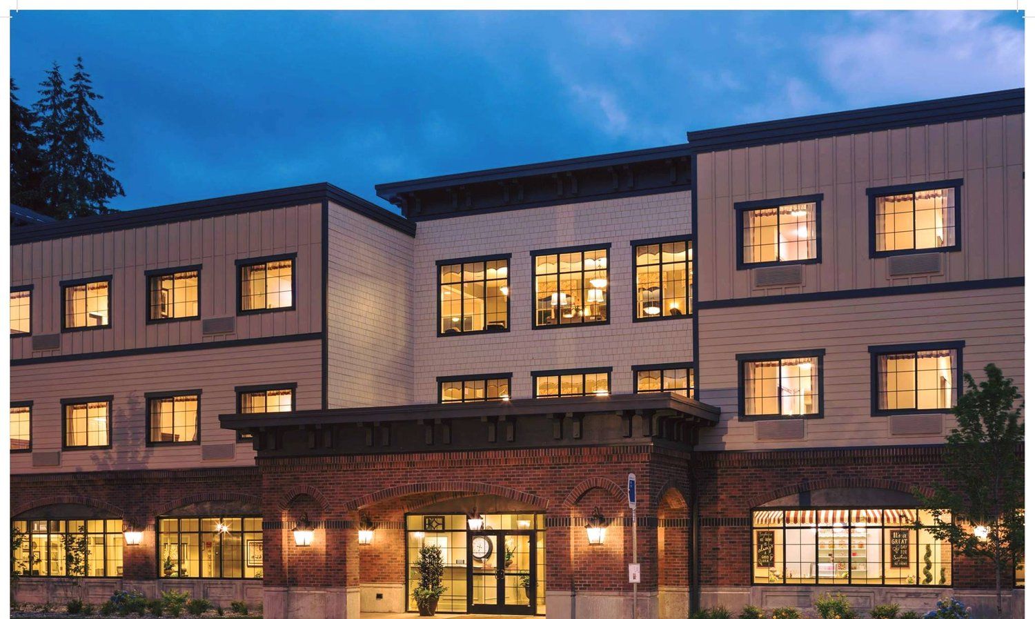 A large building with lots of windows is lit up at night