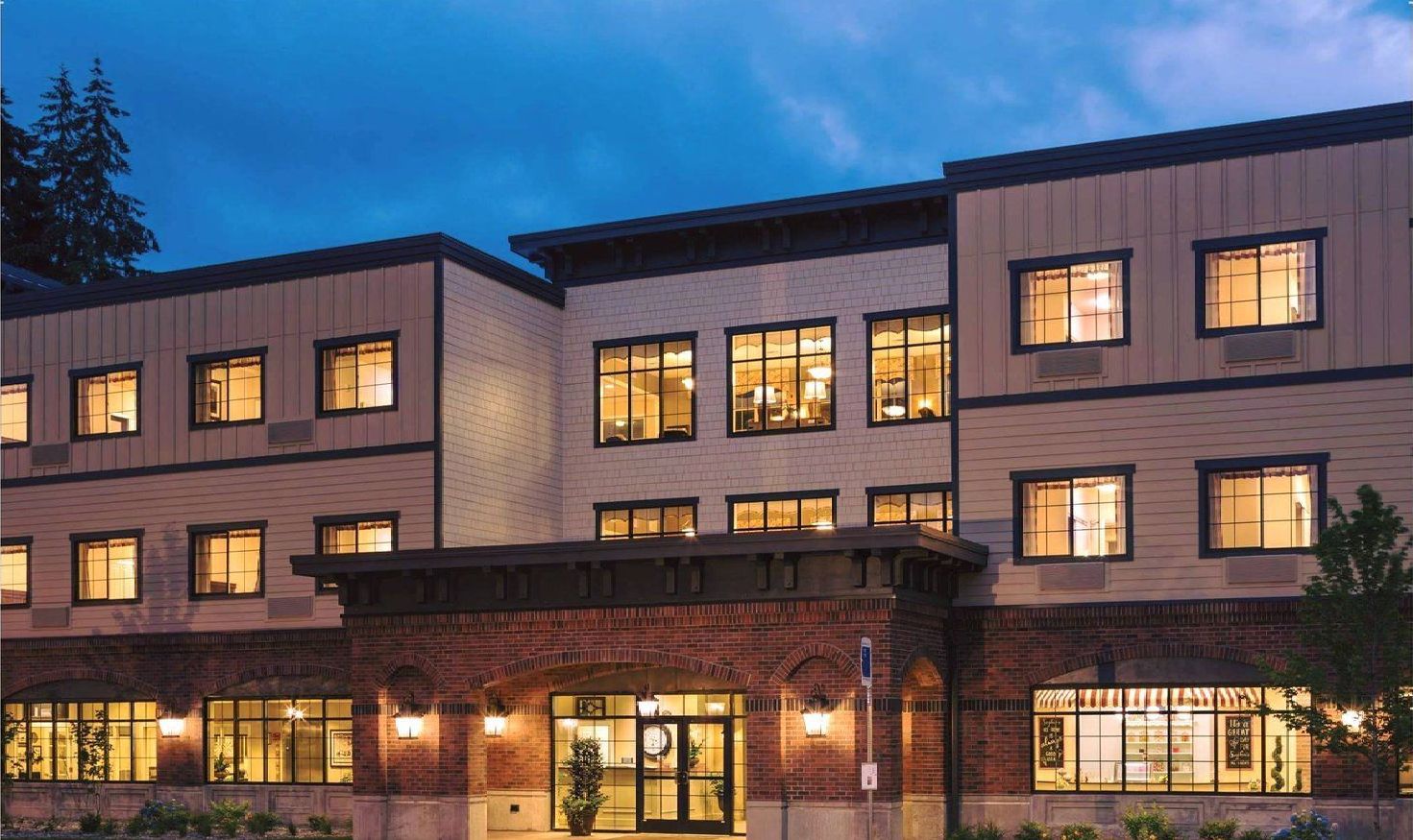 A large building with lots of windows is lit up at night