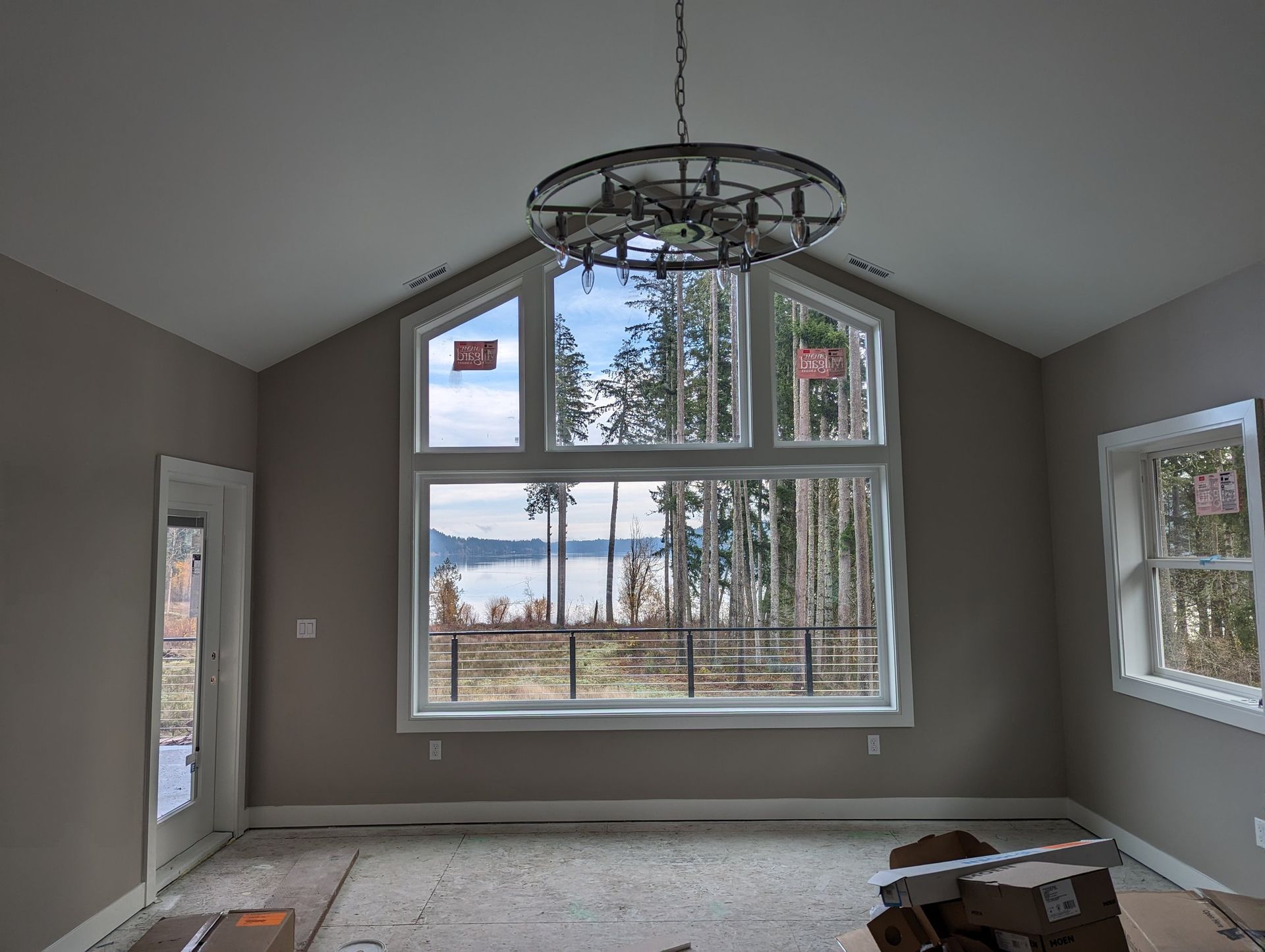 A room with a lot of windows and a chandelier hanging from the ceiling