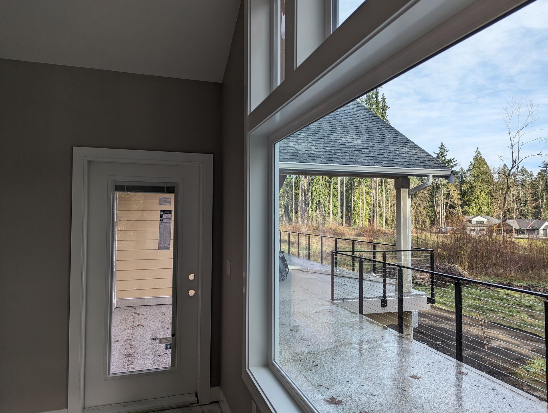 An empty room with a large window and a door