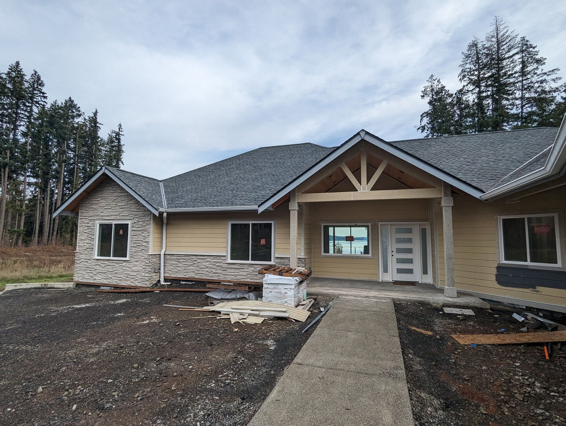 A house that is being built with a gray roof