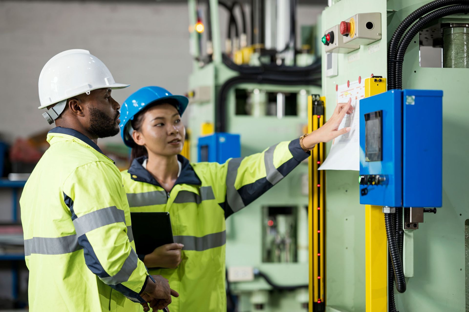 Technicians discussing a process control plan at an electrical company. Technicians discussing a process control plan at an electrical company.