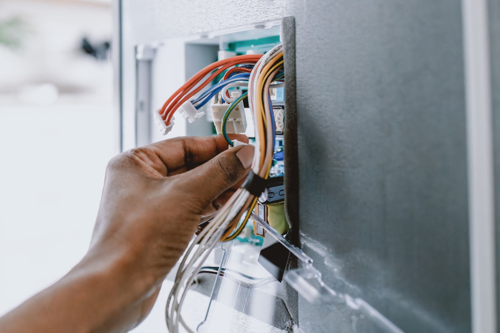 Woman Repairs Refrigerator's Core Circuit Board