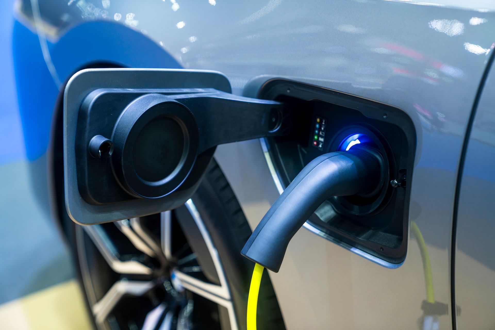 A close up of an electric car being charged.