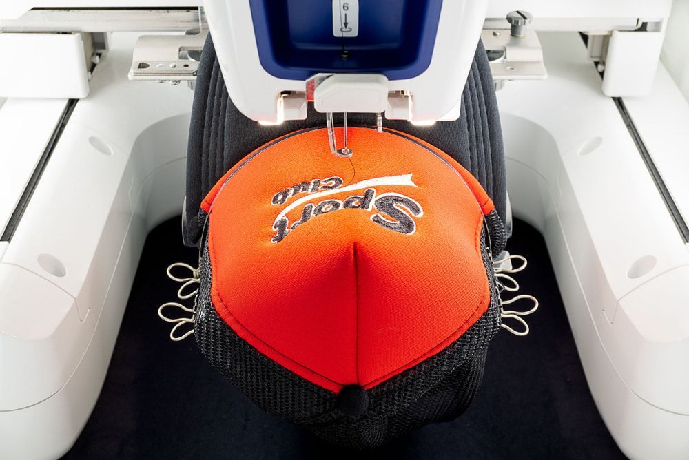 A Hat Is Being Embroidered with The Word Sport on It — CKM Screen Printing in West Gosford, NSW