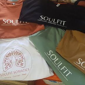 A Bunch of T-Shirts Are Stacked on Top of Each Other in A Basket — CKM Screen Printing in West Gosford, NSW