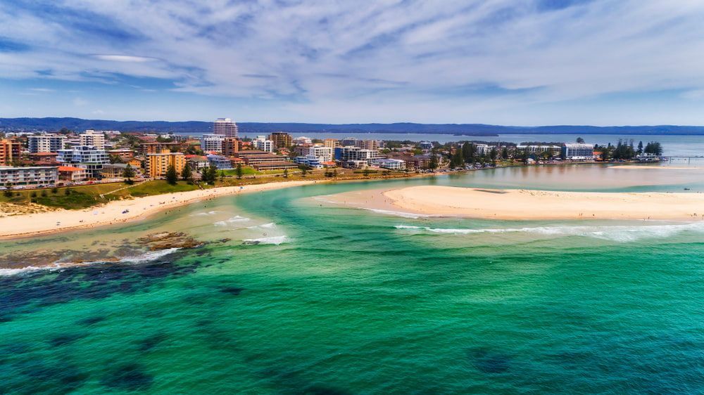 An Aerial View of A Beach with A City in The Background — CKM Screen Printing in Tuggerah, NSW