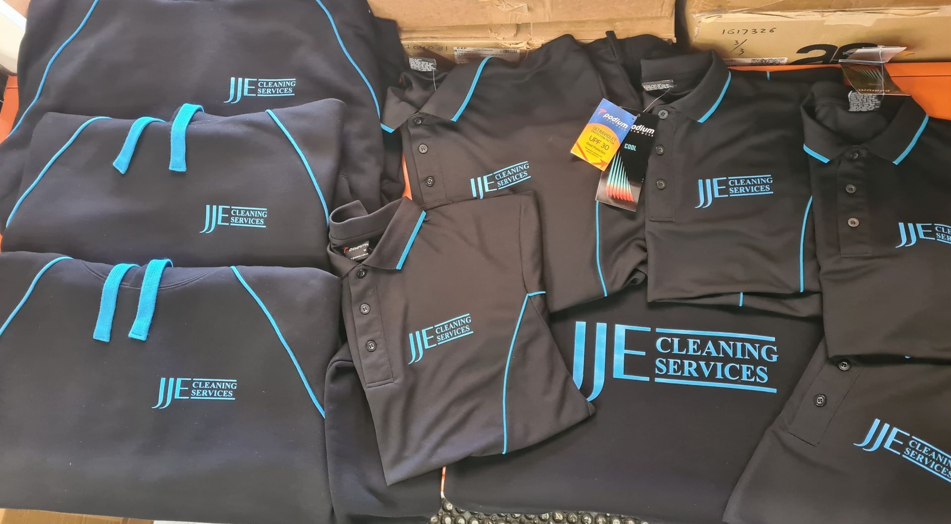 A Row of Colorful T-Shirts Are Sitting on A Conveyor Belt — CKM Screen Printing in Woy Woy, NSW