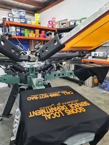 A T-Shirt that Says Service Department Is Being Printed on A Machine — CKM Screen Printing in West Gosford, NSW