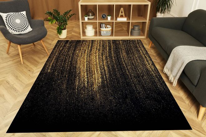 Living room with a black and gold glitter rug, gray sofa and chair, and wooden shelf.