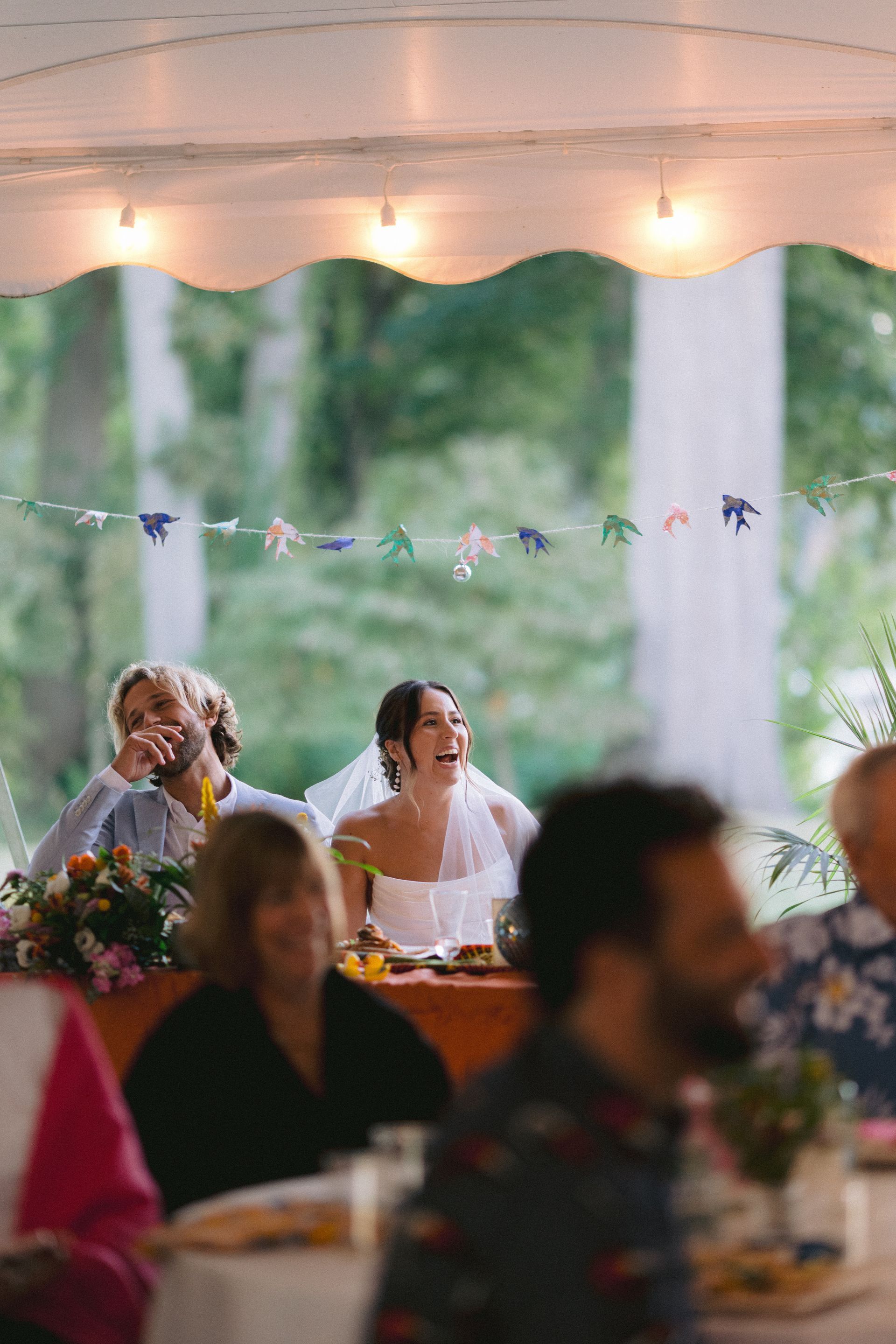 couple sitting at head table listening to speech