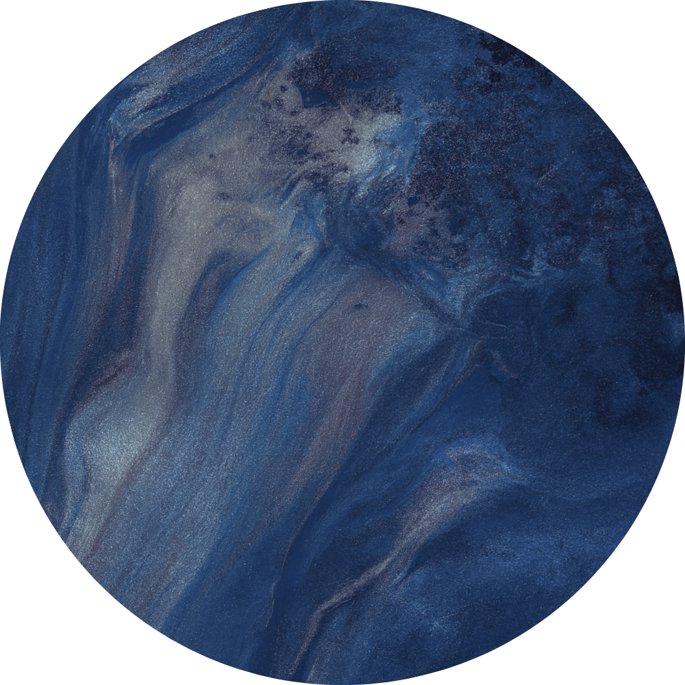Abstract, circular image with swirling shades of blue, gray, and white, resembling an ocean or nebula.