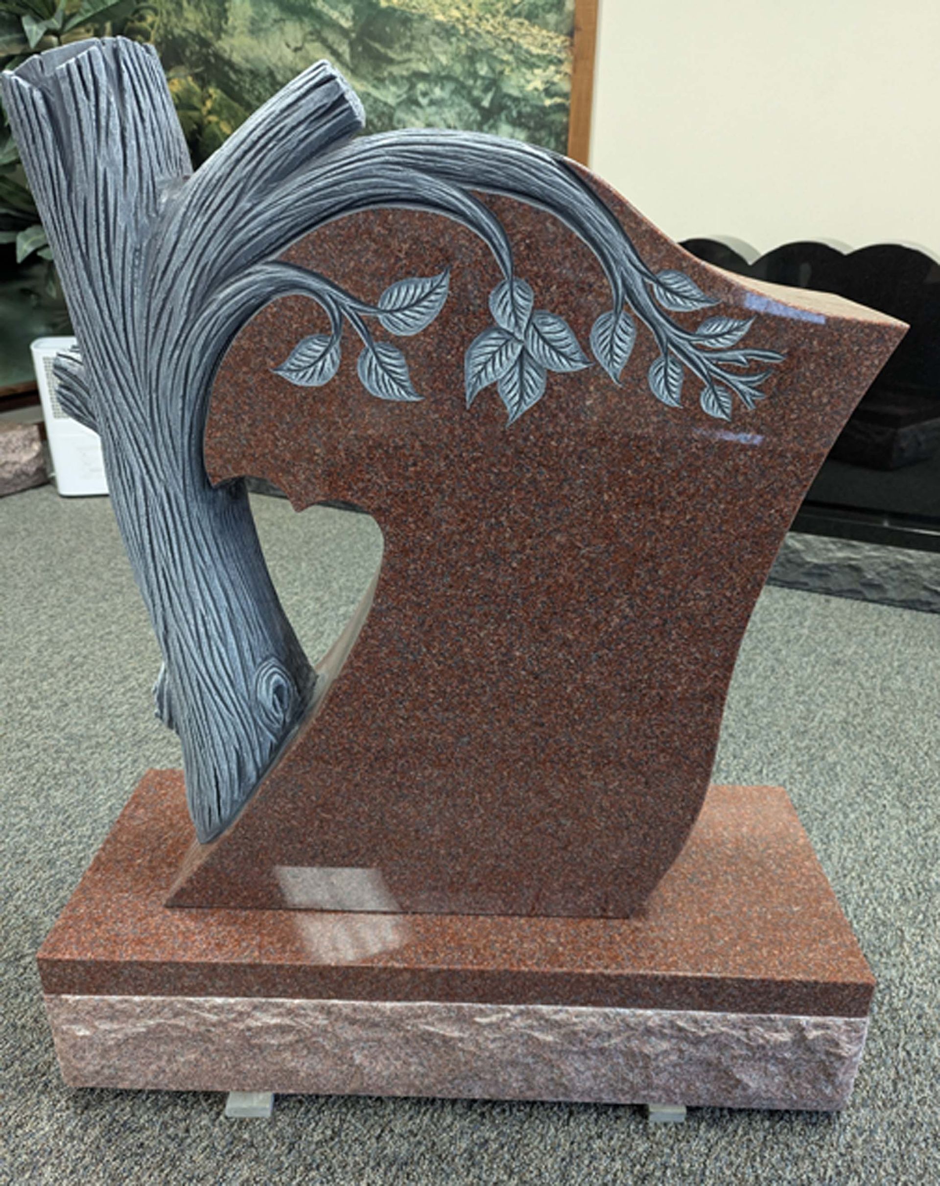 An advertisement for custom design monuments with a picture of a heart