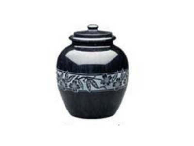 A black urn with a white floral design on it on a white background.