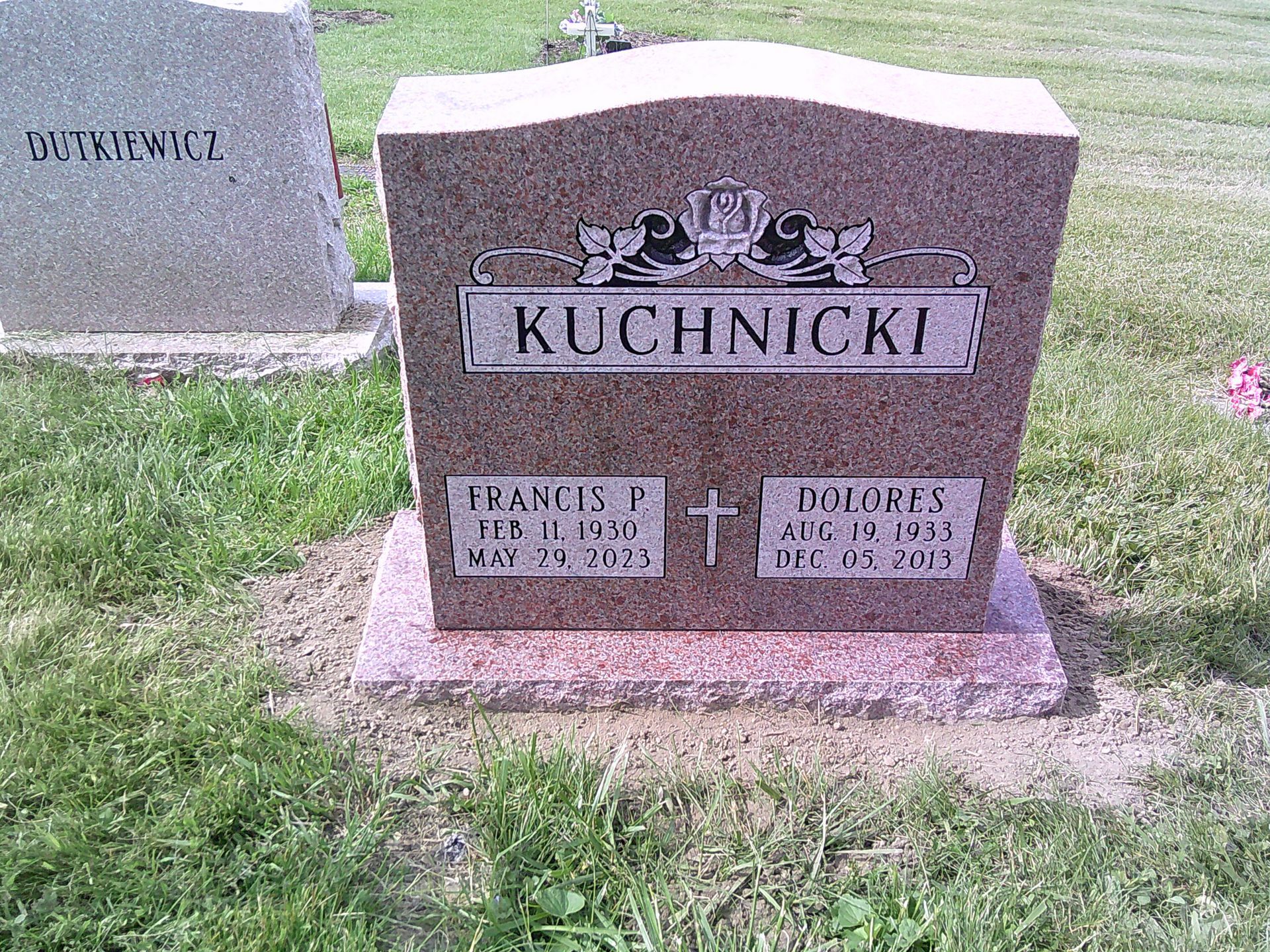 A gravestone in a cemetery with the name kuchnicki on it