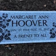 A gravestone for margaret ann hoover is sitting in the dirt.