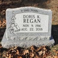 A gravestone for doris k. regan in a cemetery.