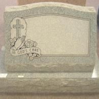 A gravestone with a cross on it and a banner that says `` in god 's care ''.