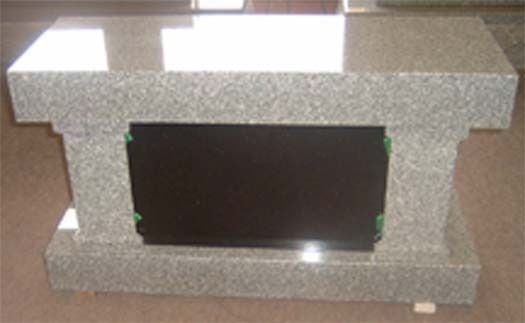 A granite table with a black plaque on it