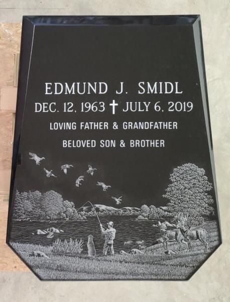 A gravestone for edmund j. smidl who died on july 6 2019